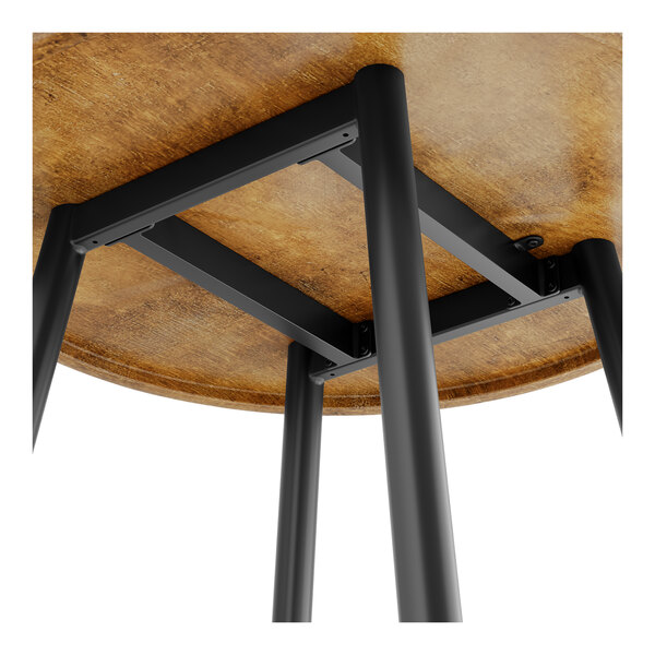 A Lancaster Table & Seating round butcher block table with black metal legs.