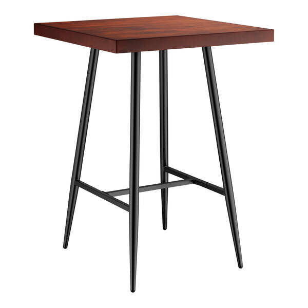 A Lancaster Table & Seating Mid-Century bar table with black legs and a mahogany top.