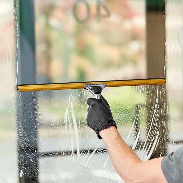 A person cleaning a window with an Ettore Super Channel squeegee.