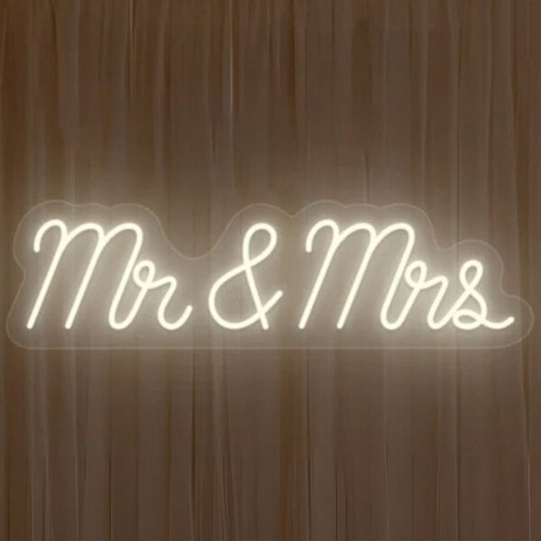 A white neon sign that says "Mr & Mrs" in a black background.