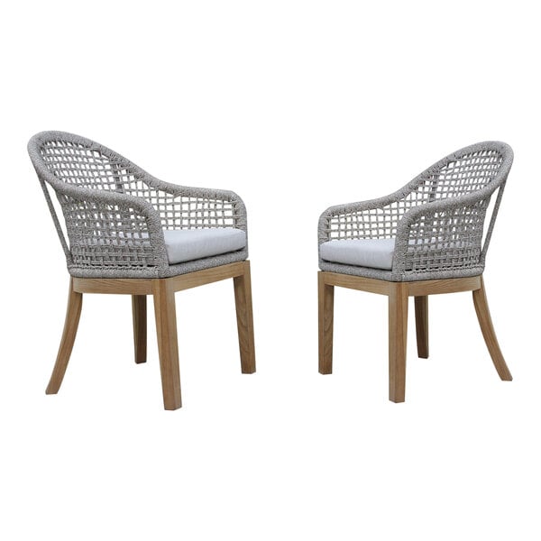 Two Outdoor Interiors teak dining chairs with white Sunbrella cushions.