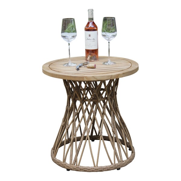 An Outdoor Interiors round teak and wicker table with wine bottles and glasses on it.