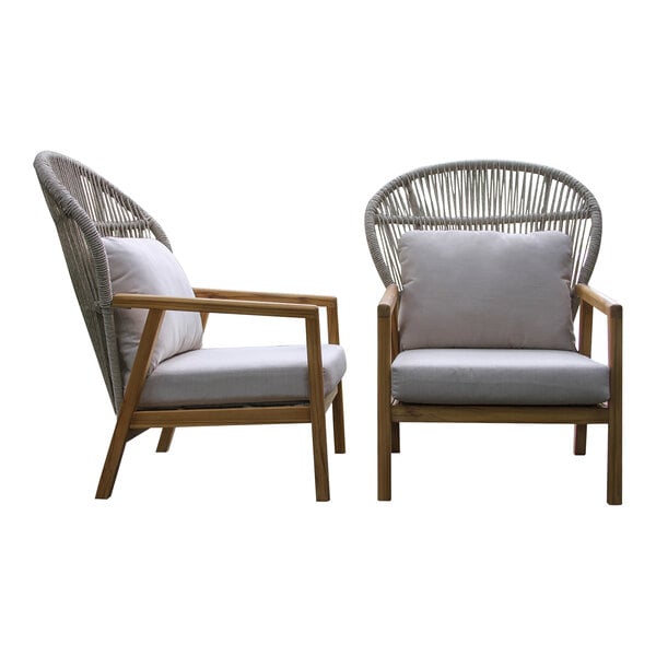 A pair of Outdoor Interiors teak and white wicker parlor chairs with gray Sunbrella cushions.