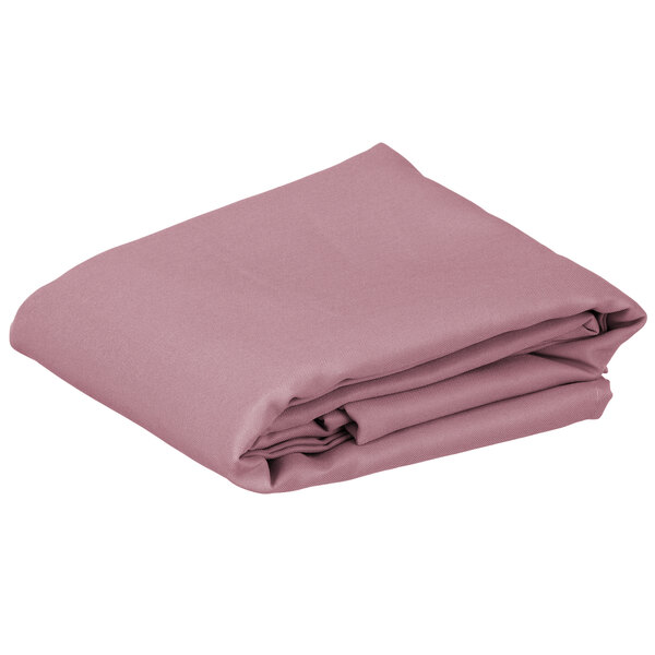 A folded pink rectangular Intedge cloth table cover.