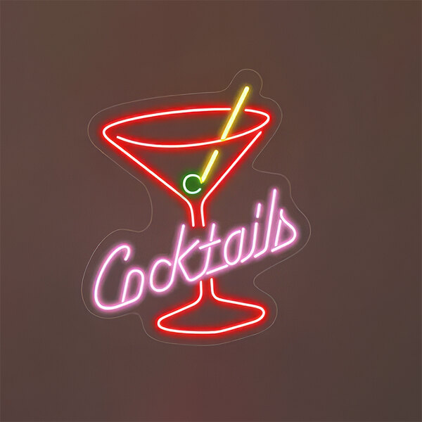 A red and pink neon sign that says "Cocktails" with green text.