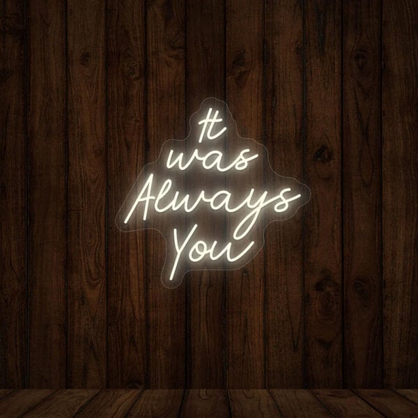 A Crazy Neon warm white LED "It Was Always You" sign on a wood wall.