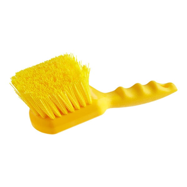 A close-up of a Lavex yellow utility and pot scrub brush with a handle.