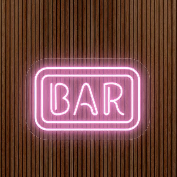 A pink neon "Bar" sign with white letters on a wood surface.