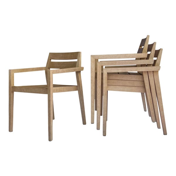 A set of four Outdoor Interiors wooden dining chairs with arms stacked together.