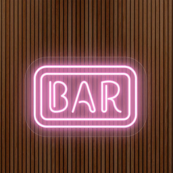 A pink neon sign that says "Bar" on a wood surface.