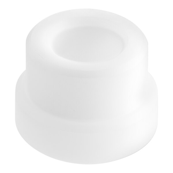 A white plastic Estella bushing with a hole and a round center.