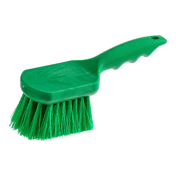 A close-up of a Lavex green polyester floating utility/pot scrub brush with a handle.