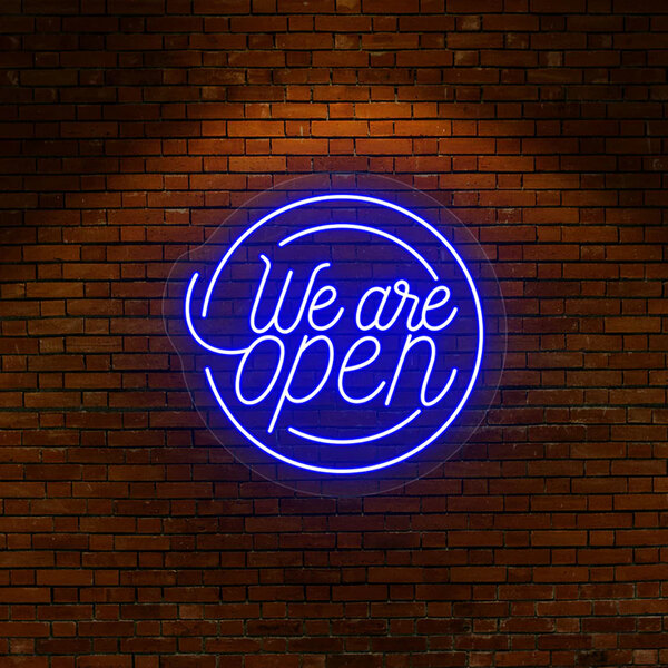 A blue Crazy Neon "We Are Open" LED sign on a brick wall.