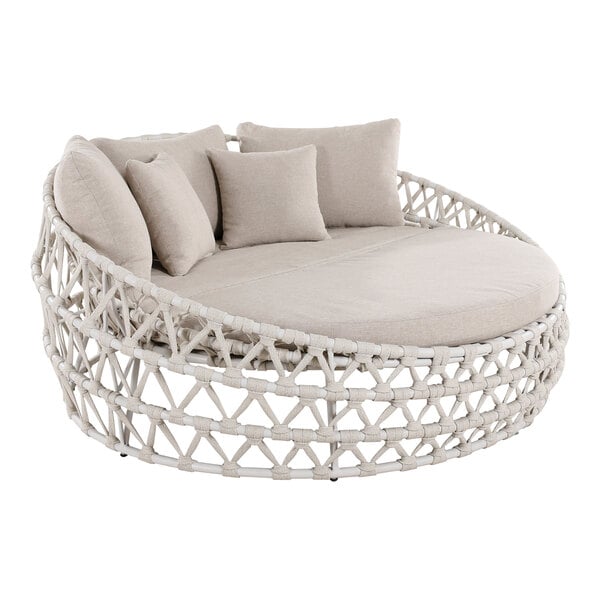 An Outdoor Interiors round rope daybed with gray cushions.