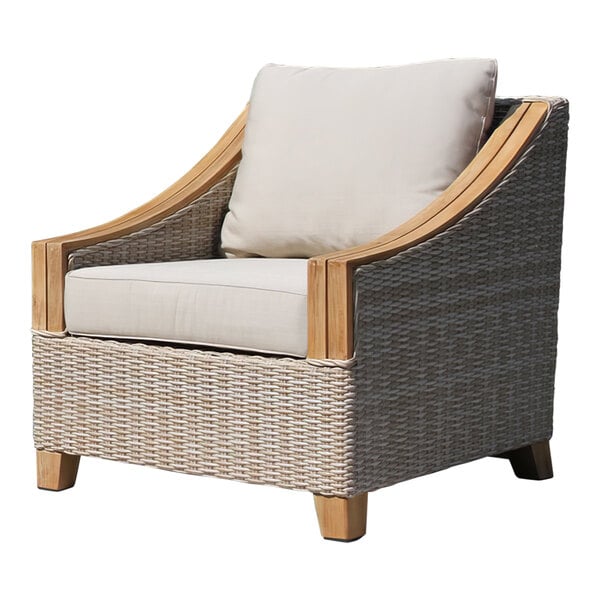 An Outdoor Interiors wicker arm chair with a white Sunbrella cushion.
