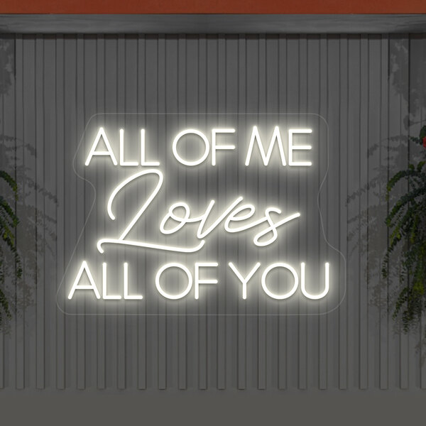 A white neon sign with the words "All of Me Loves All of You" in warm white LED.