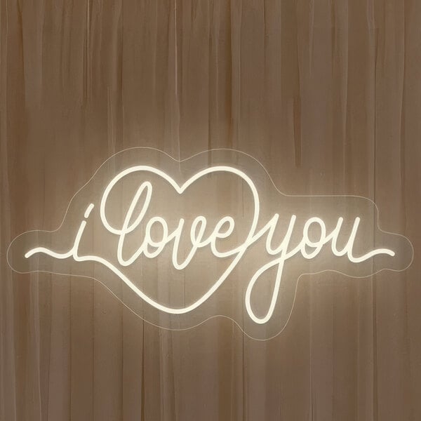 A white neon sign in the shape of a heart that says "I Love You" on a white background.