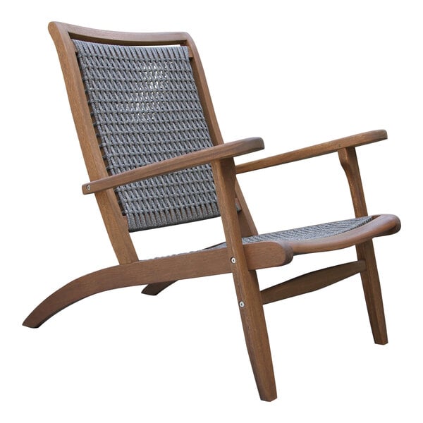 An Outdoor Interiors wicker and eucalyptus lounger with a woven seat and back.