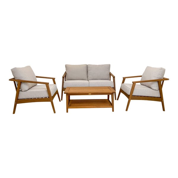 An Outdoor Interiors Eucalyptus conversation set with white cushions on a group of wooden chairs and a coffee table.