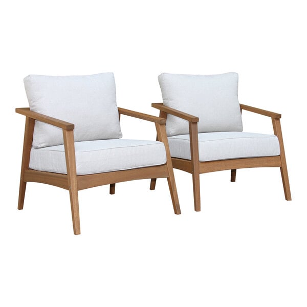 Two Outdoor Interiors Eucalyptus arm chairs with white cushions on them.