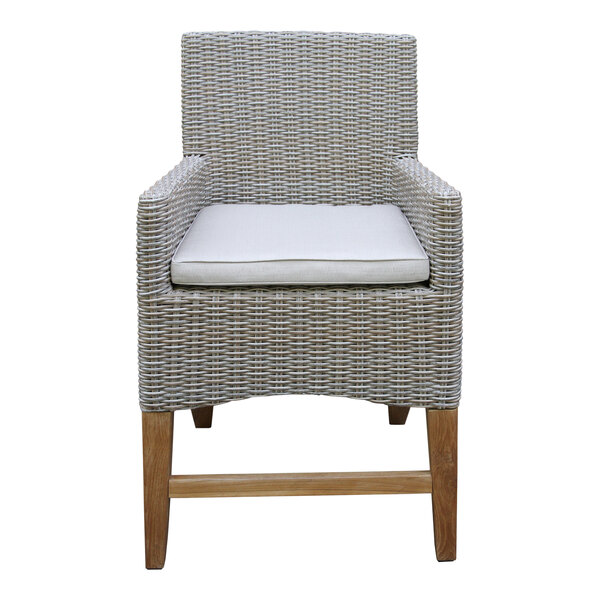 An Outdoor Interiors wicker chair with white cushion on a wooden frame.