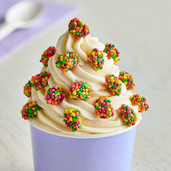 A cup of ice cream with colorful Nerds candy on top.