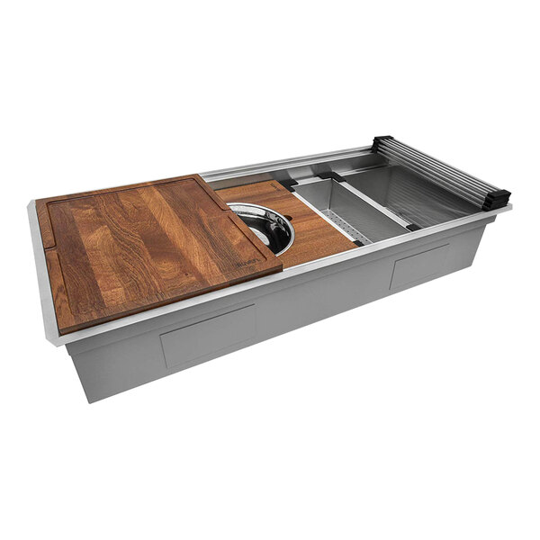 A Ruvati stainless steel workstation sink with a wood cutting board over the sink.