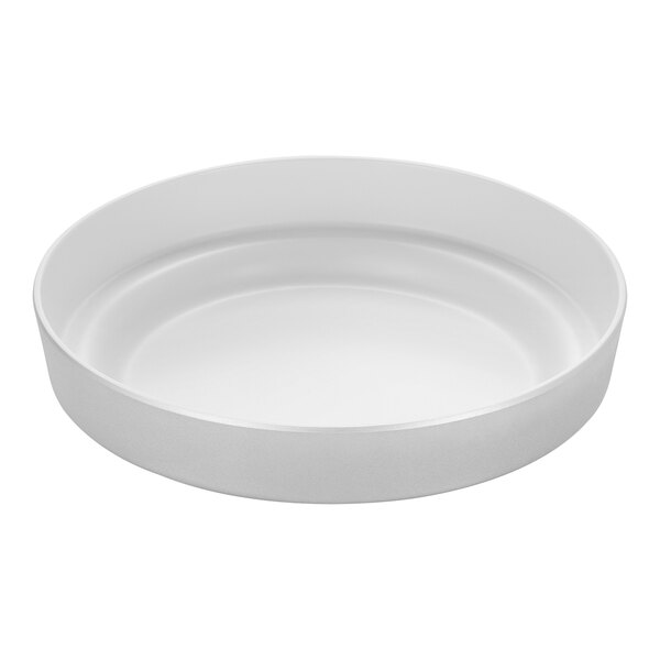 An American Metalcraft silver melamine tray with a round rim on a white surface.