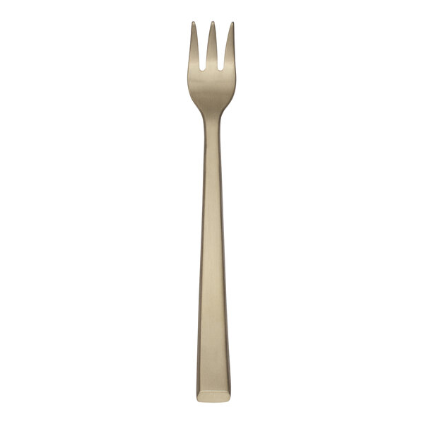 A stainless steel cocktail fork with a gold handle.