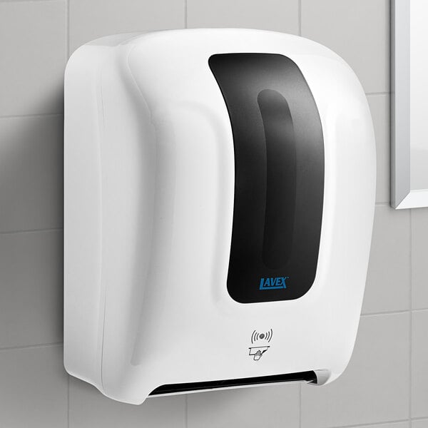 A white Lavex automatic paper towel dispenser on a wall.