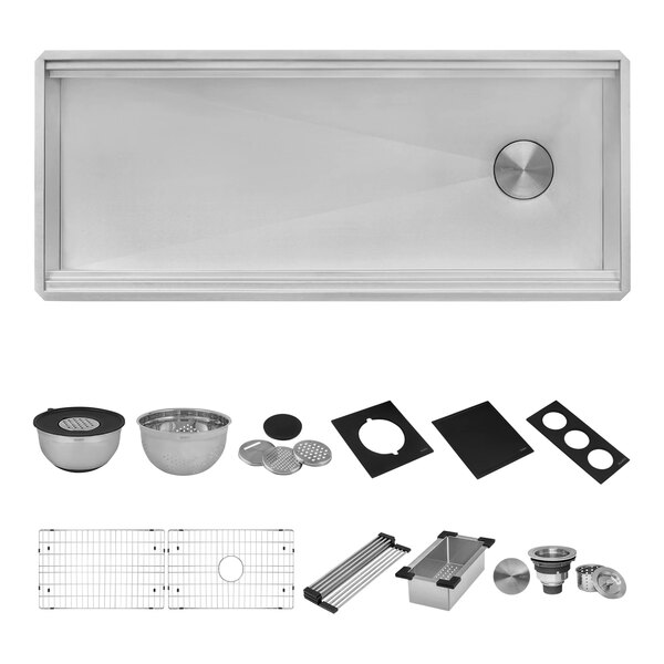 A close-up of a Ruvati stainless steel dual-tier workstation sink with accessories inside.