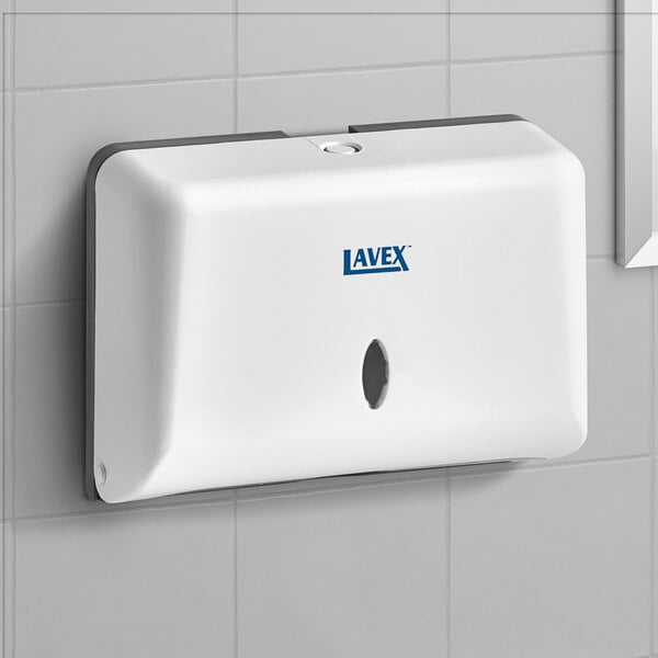 A white rectangular Lavex mini paper towel dispenser.