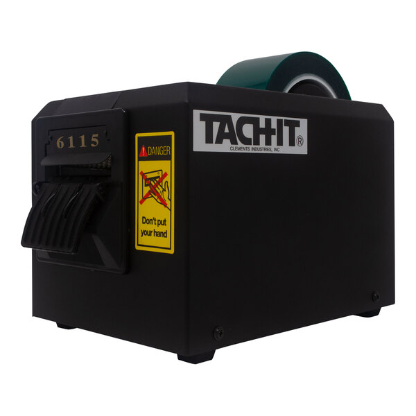 A black Tach-It Heavy-Duty Automatic Definite Length Tape Dispenser with a roll of green tape.