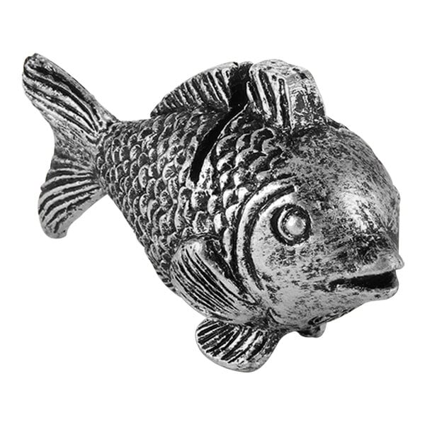 A silver fish shaped card holder with a metal charm in the shape of a fish.