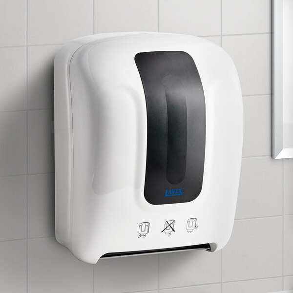 A white Lavex manual paper towel dispenser on a wall.