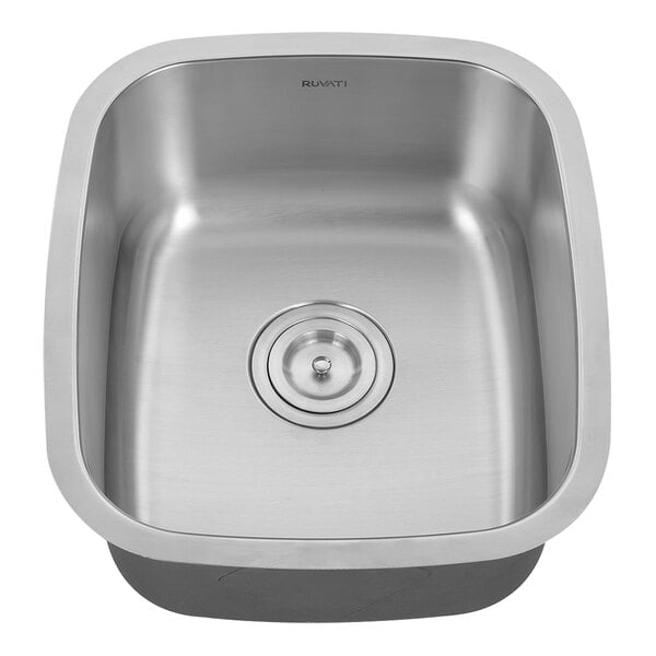 A Ruvati stainless steel sink with a drain.