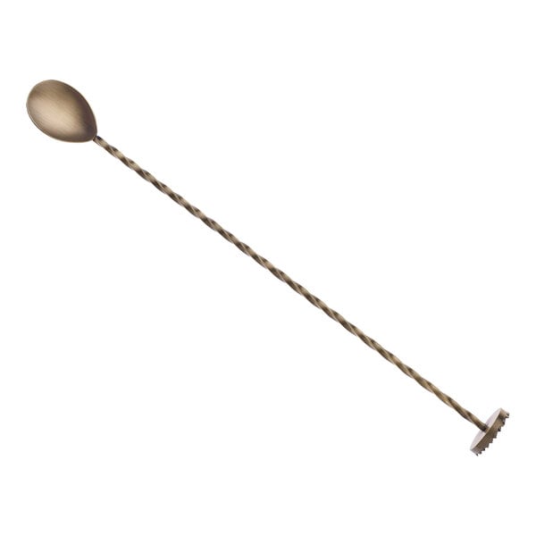 A Barfly antique gold bar spoon with a long handle.