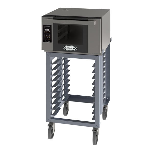 A Cadco Bakerlux countertop convection oven on a stand with wheels.