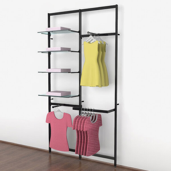 A Udizine black wall-mount retail clothing display with shelves, faceouts, and a hanging rail holding pink shirts.