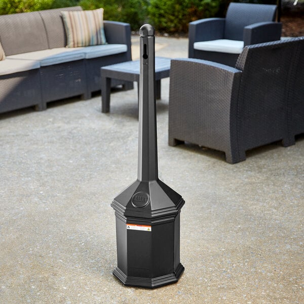 A black metal Lavex freestanding cigarette receptacle on a concrete surface.