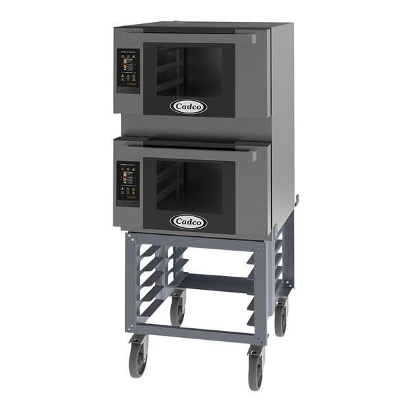 A black metal stand holding two Cadco Bakerlux countertop convection ovens.