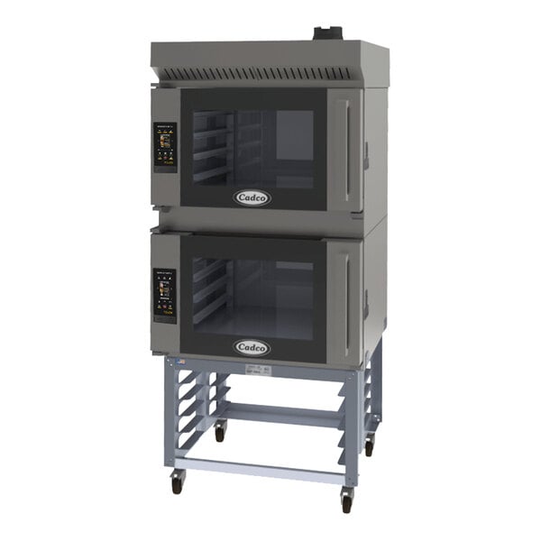 A black and grey Cadco Bakerlux double stacked countertop convection oven on a stand with wheels.