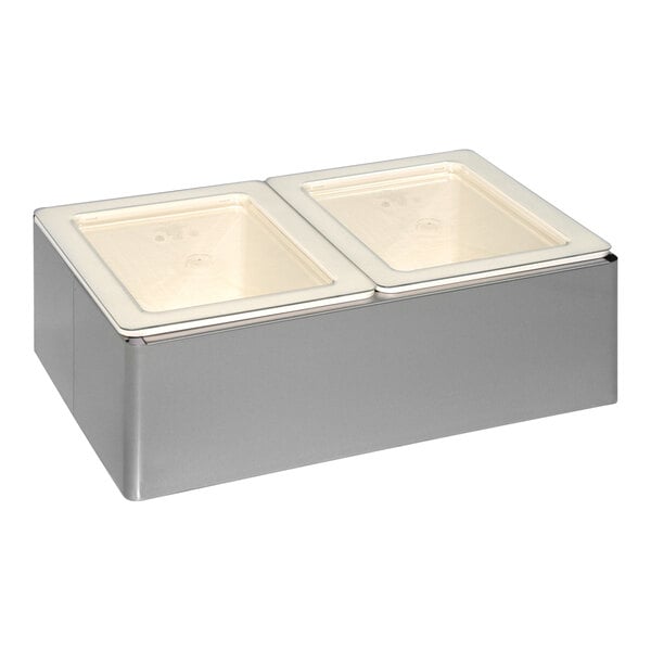 A silver rectangular Cadco cold pan holder with two white rectangular lids over two rectangular pans.