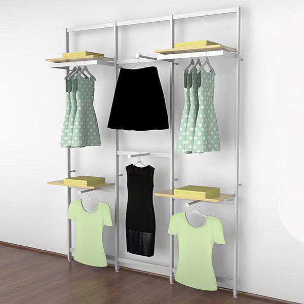 A white Udizine wall-mount retail clothing display rack with clothes on it.