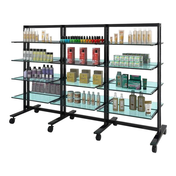 A black Udizine mobile retail clothing display stand with shelves holding various bottles.