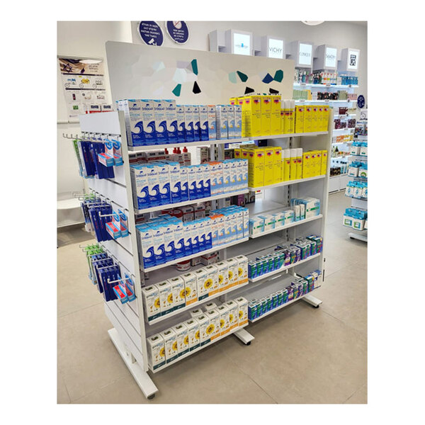 A white Udizine mobile retail clothing display stand with shelves holding white boxes with black text.