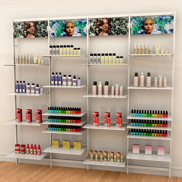 A white Udizine retail clothing display shelf with various bottles on it.