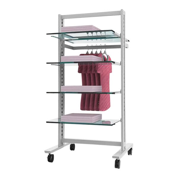 A white Udizine mobile retail clothing display rack with clothes on a shelf.