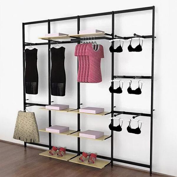 A black Udizine wall-mount retail clothing display rack with faceouts and shelves for hanging clothes.