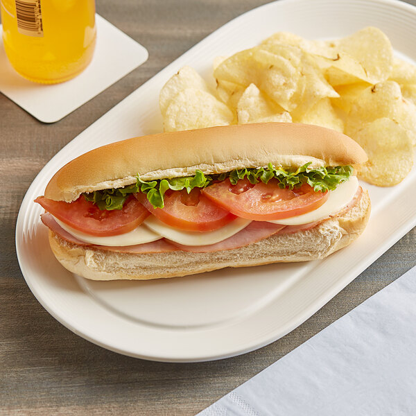 A sandwich made with Martin's Famous Sliced Hoagie Rolls on a plate with chips.